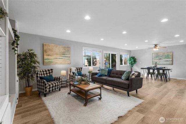 living area with light wood-style floors, recessed lighting, and baseboards