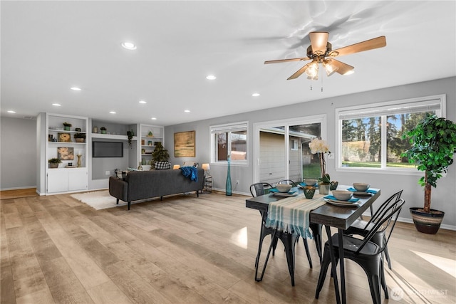 dining room featuring baseboards, light wood-style flooring, and recessed lighting