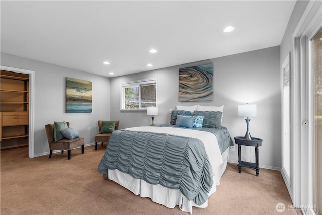 bedroom featuring carpet floors, baseboards, a walk in closet, and recessed lighting