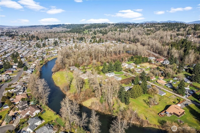 birds eye view of property featuring a residential view, a water view, and a wooded view