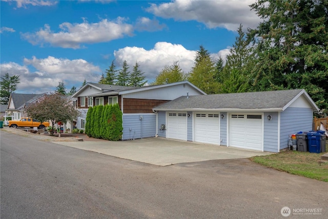 ranch-style house with concrete driveway and an attached garage