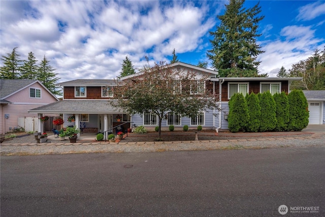 view of front of house featuring a garage and covered porch