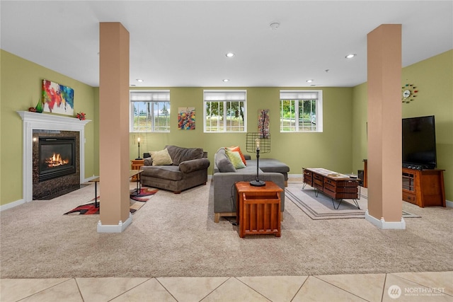 tiled living area with carpet floors, a high end fireplace, and recessed lighting