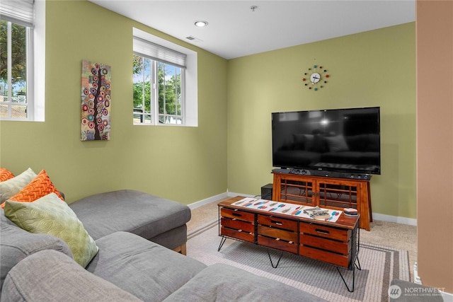 carpeted living area with visible vents and baseboards