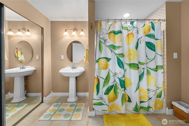 bathroom featuring curtained shower, tile patterned floors, and baseboards