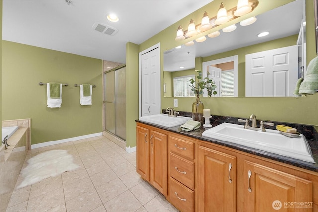 full bathroom featuring a shower stall, a sink, visible vents, and tile patterned floors