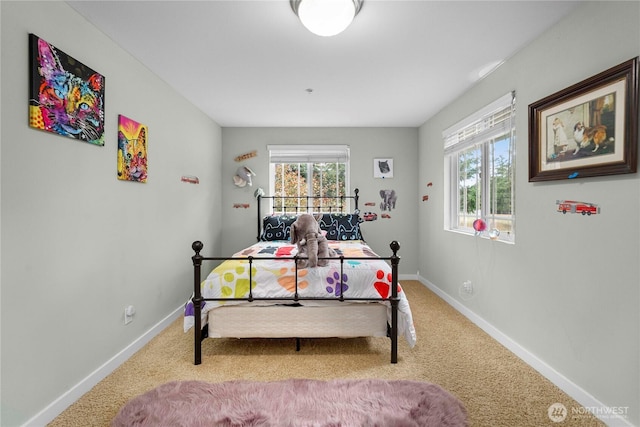 carpeted bedroom featuring baseboards