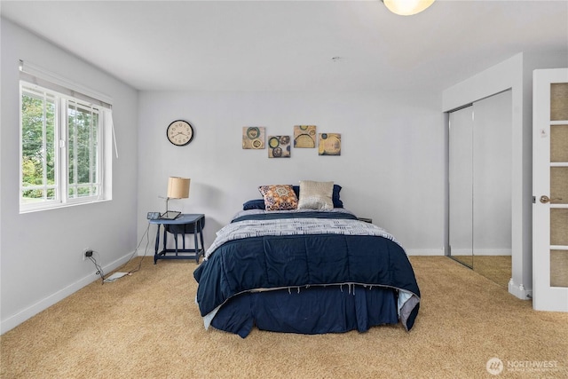 bedroom with carpet, a closet, and baseboards