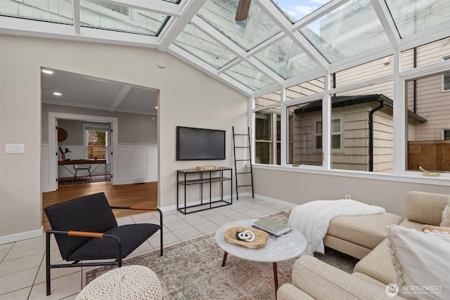 sunroom / solarium featuring vaulted ceiling with skylight