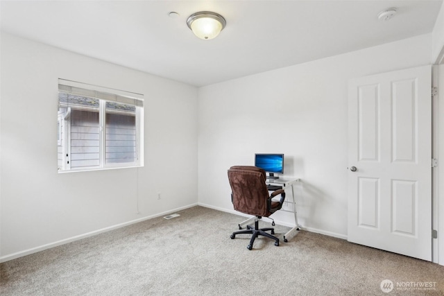 unfurnished office featuring baseboards, visible vents, and carpet floors