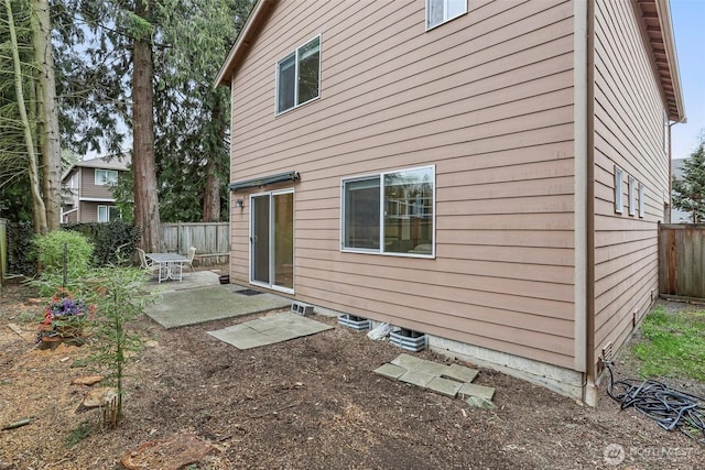 rear view of property with a patio and a fenced backyard