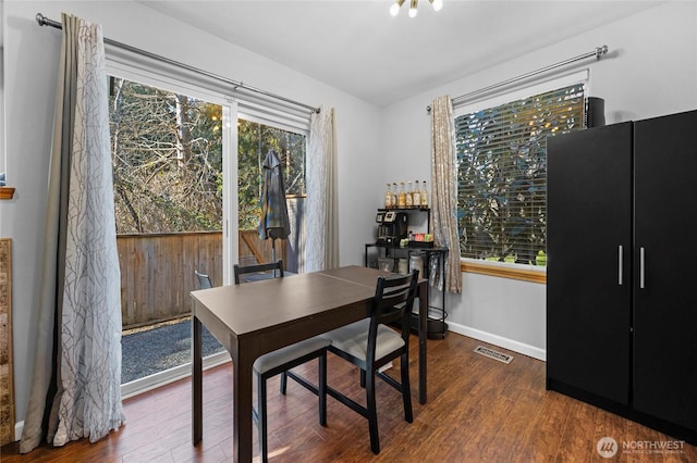 office area featuring wood finished floors, visible vents, and baseboards