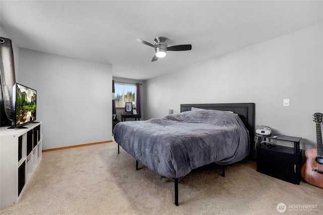 bedroom featuring baseboards, a ceiling fan, and light colored carpet