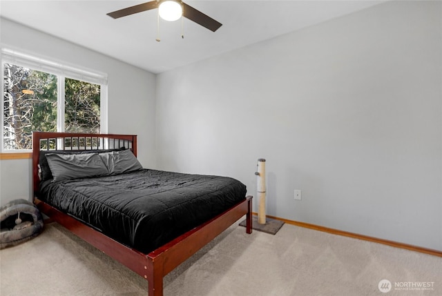 bedroom featuring baseboards, a ceiling fan, and light colored carpet