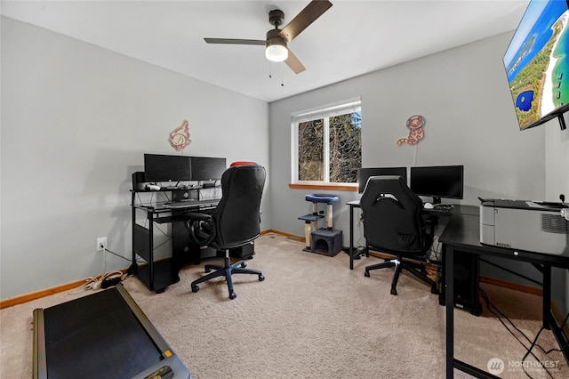 carpeted home office featuring ceiling fan and baseboards