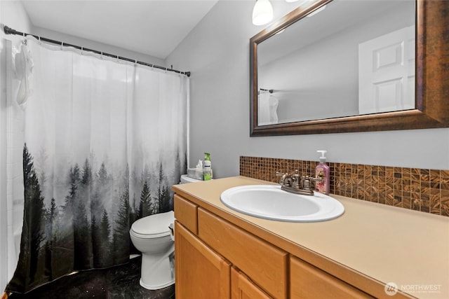 bathroom with tasteful backsplash, vanity, and toilet