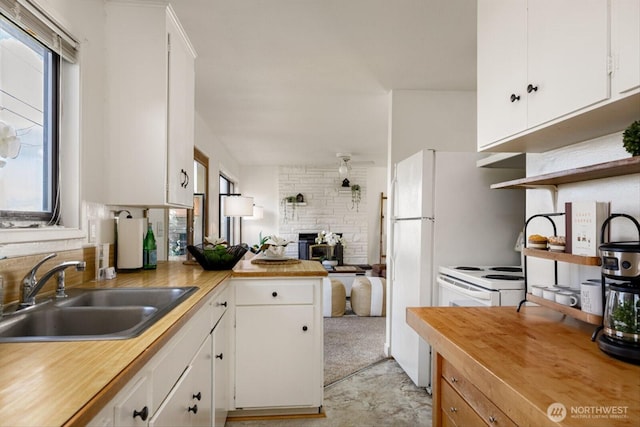 kitchen with plenty of natural light, a sink, and white cabinets