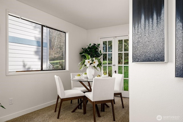 dining room with carpet floors, french doors, and baseboards