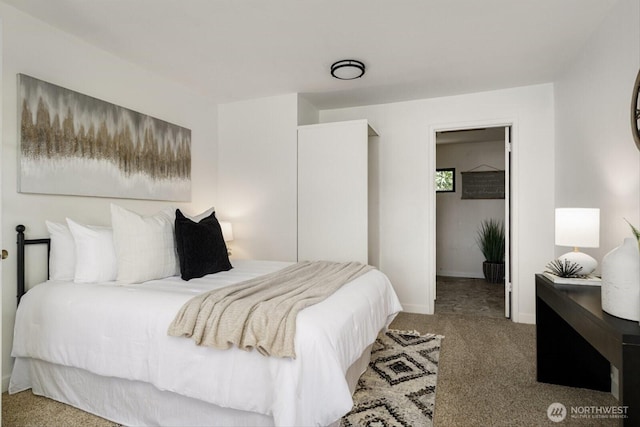 bedroom featuring carpet flooring and baseboards