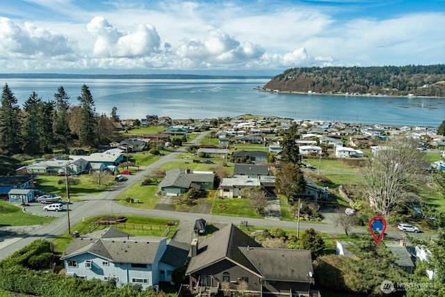 drone / aerial view featuring a water view and a residential view