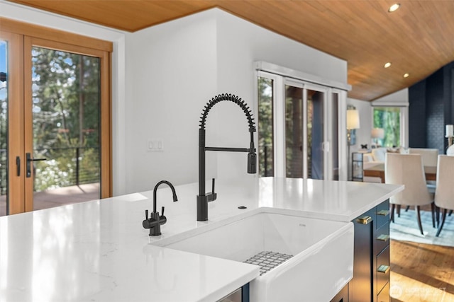 kitchen with recessed lighting, light countertops, a sink, wood finished floors, and wooden ceiling