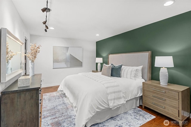 bedroom featuring baseboards, dark wood-type flooring, and recessed lighting