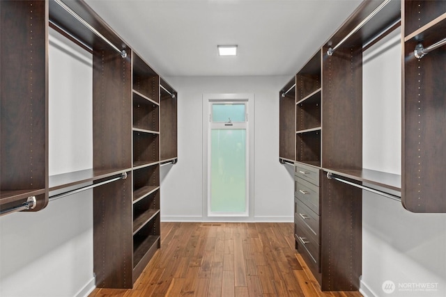 walk in closet featuring wood finished floors
