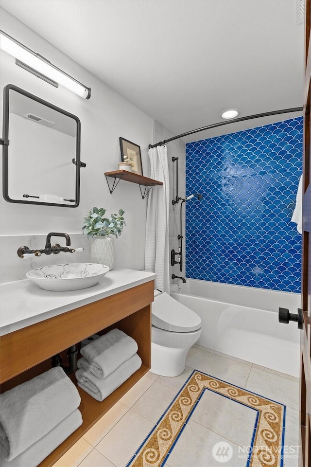 bathroom featuring toilet, vanity, shower / tub combo with curtain, and tile patterned floors