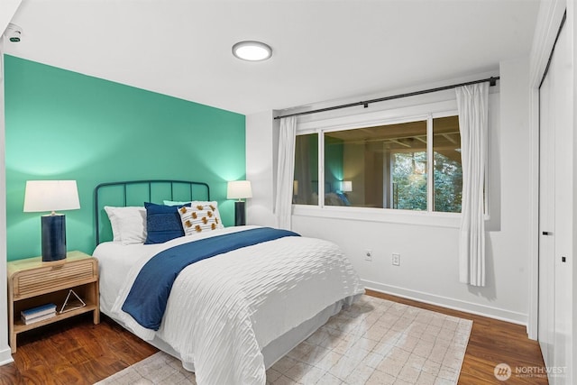 bedroom featuring baseboards and wood finished floors
