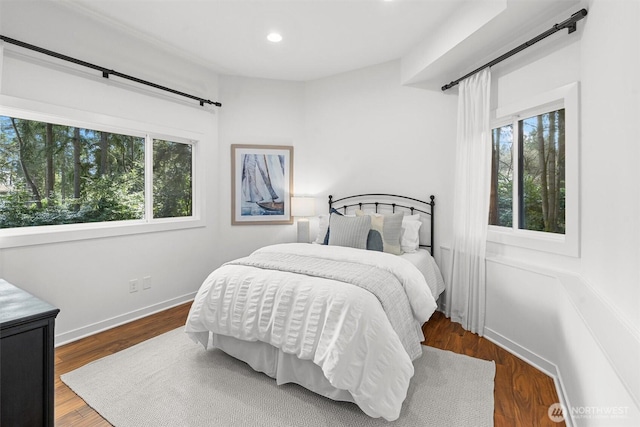bedroom with multiple windows, wood finished floors, and recessed lighting