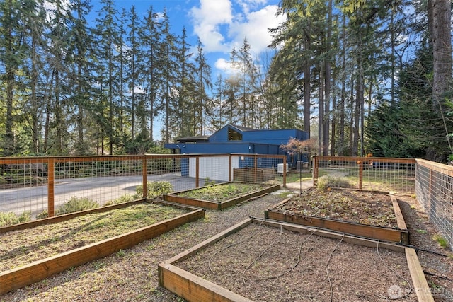 view of yard featuring a vegetable garden and fence