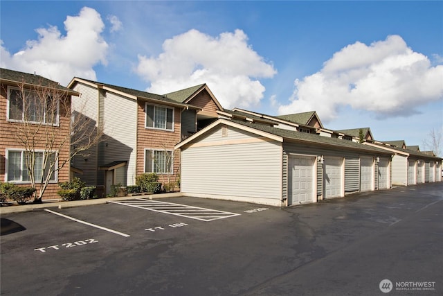 exterior space with uncovered parking and community garages