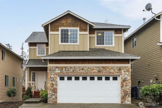 view of front of house featuring a garage, a shingled roof, and board and batten siding