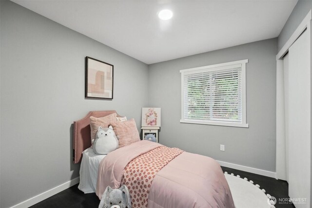 bedroom featuring a closet and baseboards