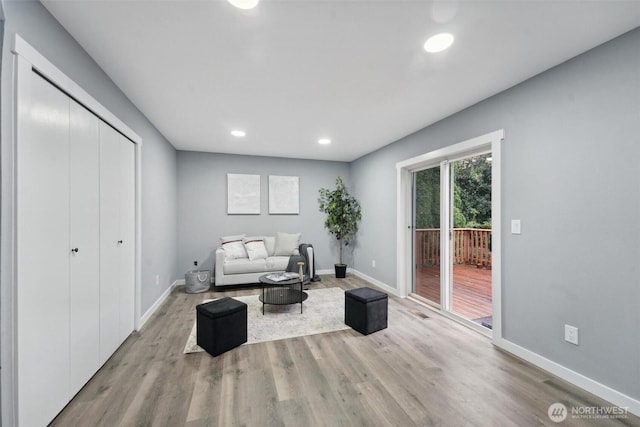 living area with recessed lighting, wood finished floors, and baseboards