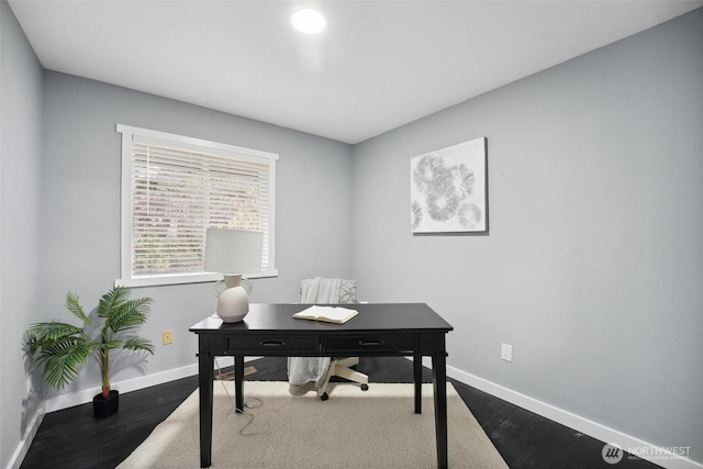 office with dark wood-style floors and baseboards