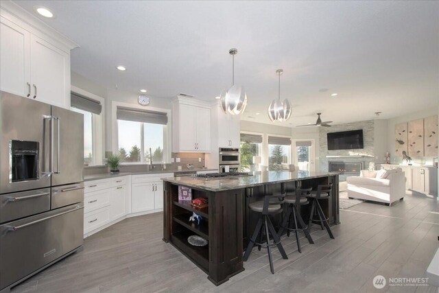 10808 NE 192nd Ave, Brush Prairie, WA 98606 - kitchen with a center island, white cabinets, stone countertops, and stainless steel appliances