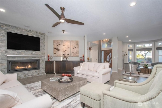 10808 NE 192nd Ave, Brush Prairie, WA 98606 - living room featuring recessed lighting, a textured ceiling, a stone fireplace, and a ceiling fan