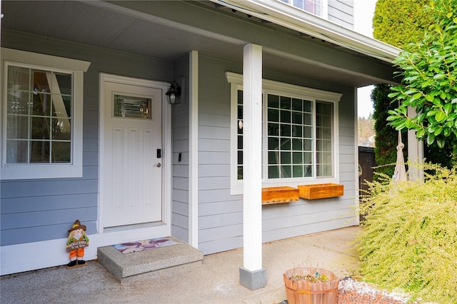 view of exterior entry featuring covered porch