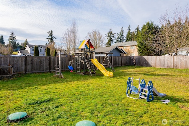 view of play area with a fenced backyard and a yard