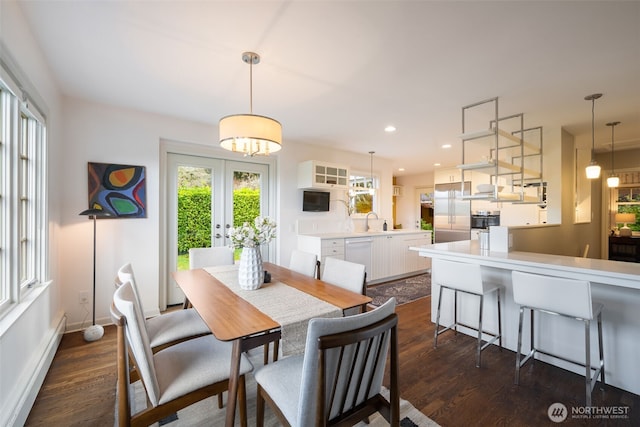 dining area featuring baseboards, dark wood finished floors, an inviting chandelier, recessed lighting, and french doors