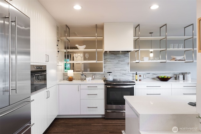 kitchen with open shelves, white cabinets, custom exhaust hood, and appliances with stainless steel finishes