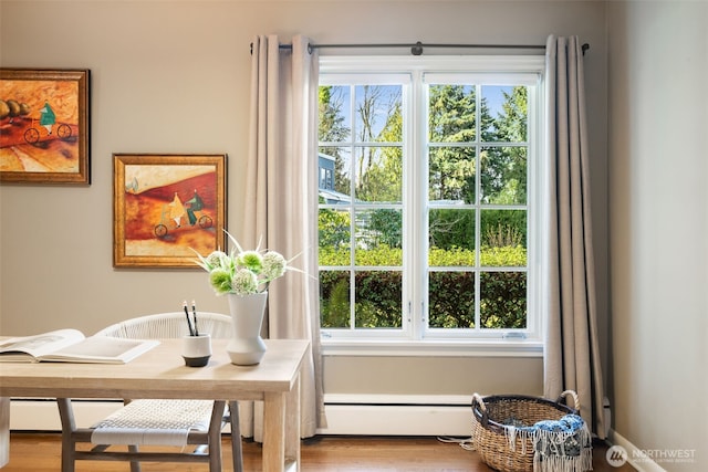 interior space with wood finished floors and a baseboard radiator