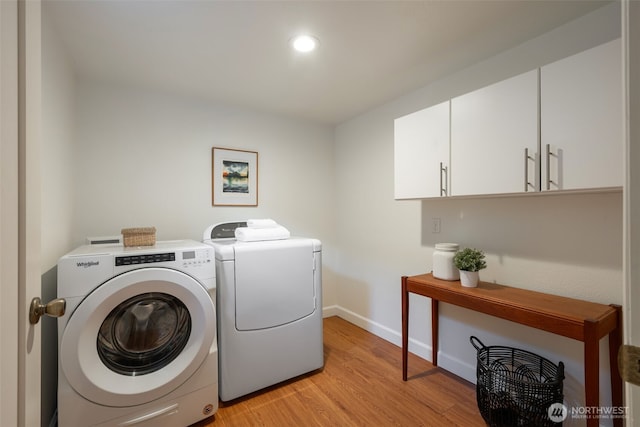 clothes washing area featuring baseboards, cabinet space, recessed lighting, separate washer and dryer, and light wood-type flooring