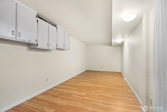 interior space featuring light wood-style flooring and baseboards