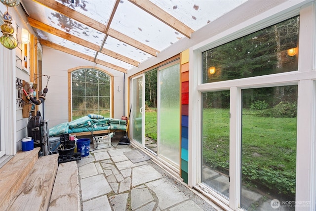 sunroom featuring vaulted ceiling