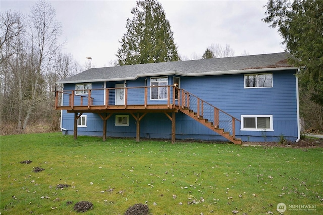 back of house with stairway, a lawn, and a wooden deck