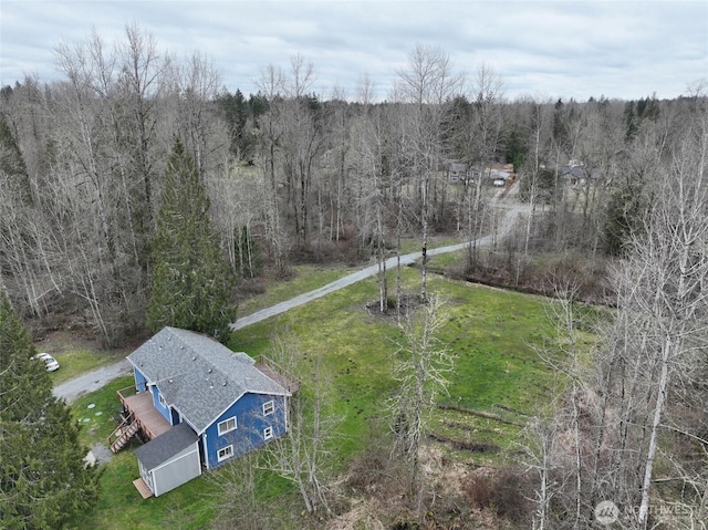 drone / aerial view featuring a wooded view