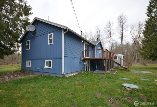 back of house with a lawn, stairs, and a deck