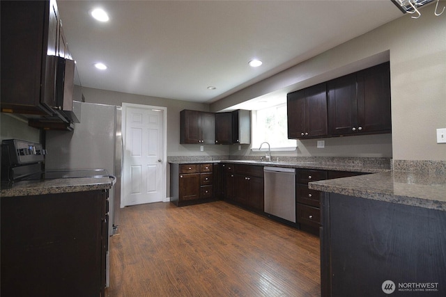 kitchen featuring a sink, dark wood-style floors, recessed lighting, stainless steel appliances, and dark brown cabinets